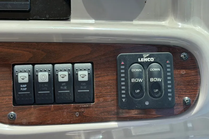 Slide: The Image of Control panel of a 2008 Chaparral Signature 290 boat with switches and Lenco trim tabs. - 36