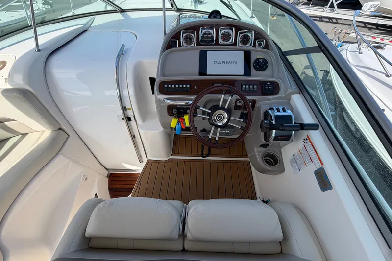 Slide: The Image of 2008 Chaparral Signature 290 boat cockpit with Garmin navigation system and wooden flooring. - 15