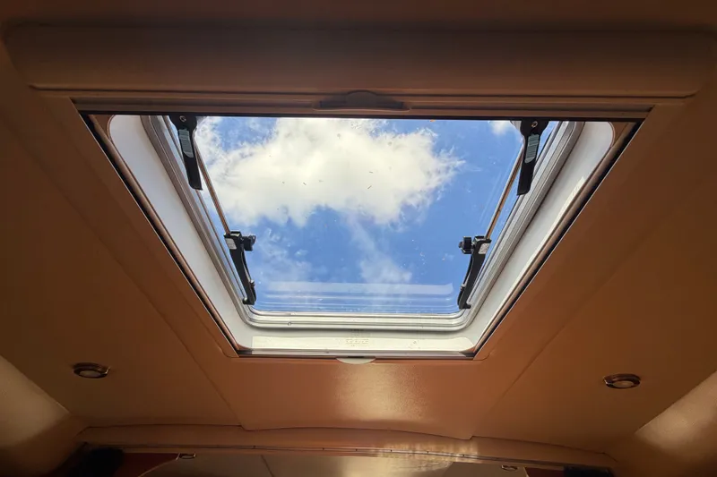 Slide: The Image of Open skylight view from 2008 Chaparral Signature 290, showcasing blue sky and clouds. - 67
