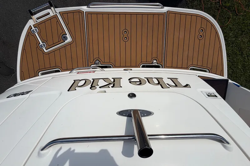 Slide: The Image of The image shows the stern of a 2008 Chaparral Signature 290 boat with a teak deck. - 38
