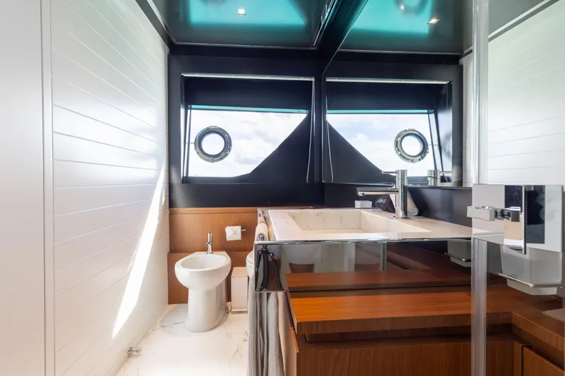 Slide: The Image of Luxurious bathroom interior of 2020 Riva 90 Argo yacht with modern fixtures and porthole windows. - 36