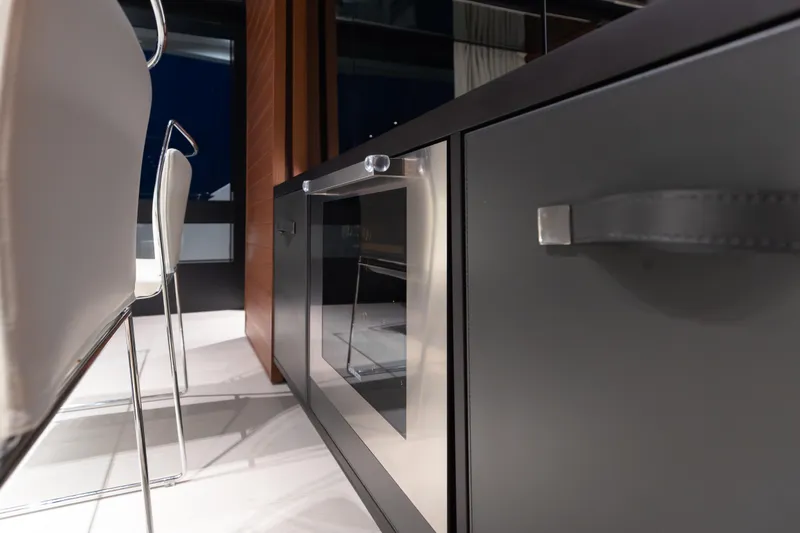 Slide: The Image of Modern interior of Riva 90 Argo yacht, featuring sleek cabinetry and elegant seating, 2020 model. - 19