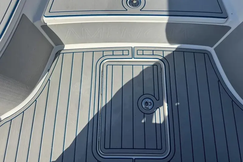 Slide: The Image of 2018 Blue Wave 2400 PureBay boat deck with sleek gray and blue design. - 37