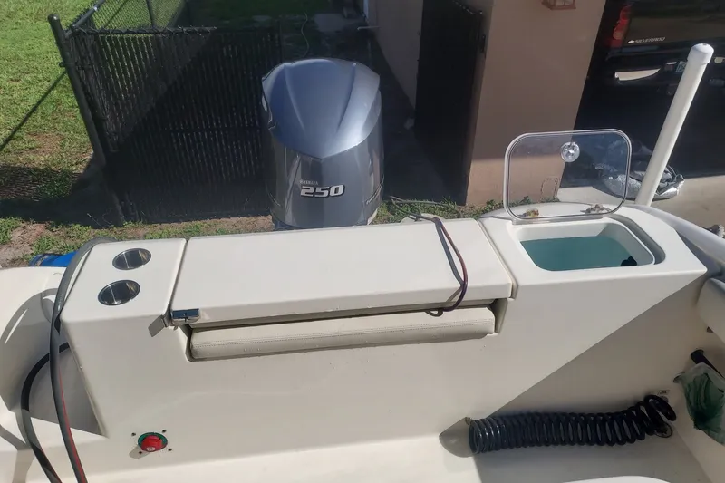 Slide: The Image of 2018 Cobia 220 Center Console boat with Yamaha 250 engine, featuring a livewell and rod holders. - 7