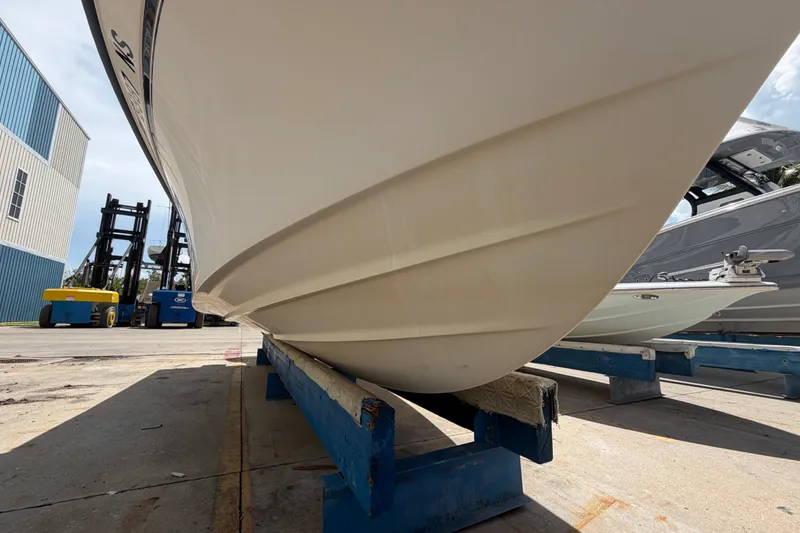 Slide: The Image of 2008 Grady-White Seafarer 226 boat hull on dry dock, with forklifts in background. - 64