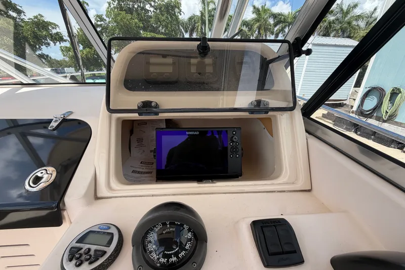 Slide: The Image of 2008 Grady-White Seafarer 226 dashboard with navigation equipment and compass. - 37