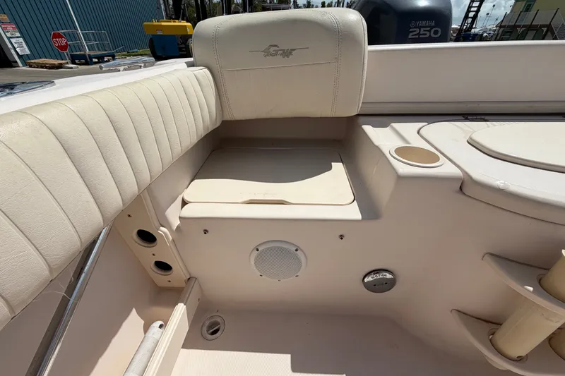 Slide: The Image of 2008 Grady-White Seafarer 226 boat interior with cushioned seating and cup holders. - 58