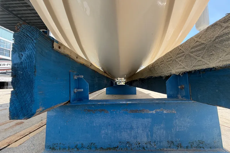 Slide: The Image of 2008 Grady-White Seafarer 226 boat hull on blue wooden supports, viewed from below. - 62