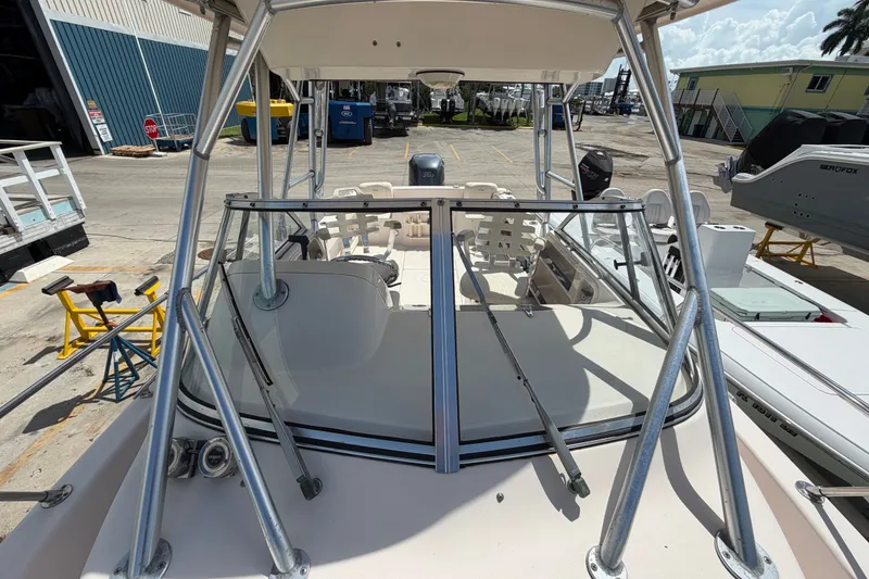 Slide: The Image of 2008 Grady-White Seafarer 226 boat with windshield and metal frame in a marina. - 13