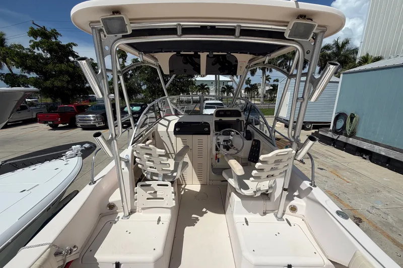 Slide: The Image of 2008 Grady-White Seafarer 226 boat interior with helm and seating, docked outdoors. - 17