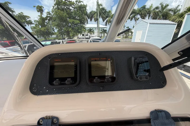 Slide: The Image of Dashboard of a 2008 Grady-White Seafarer 226 boat with tachometer and speed fuel gauges. - 38