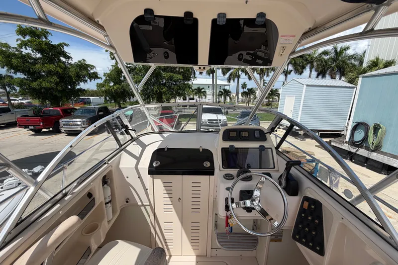 Slide: The Image of 2008 Grady-White Seafarer 226 boat cockpit with steering wheel and control panel. - 21