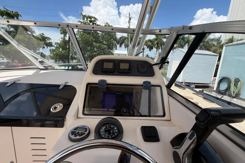 Slide: The Image of 2008 Grady-White Seafarer 226 boat dashboard with steering wheel and navigation instruments. - 36
