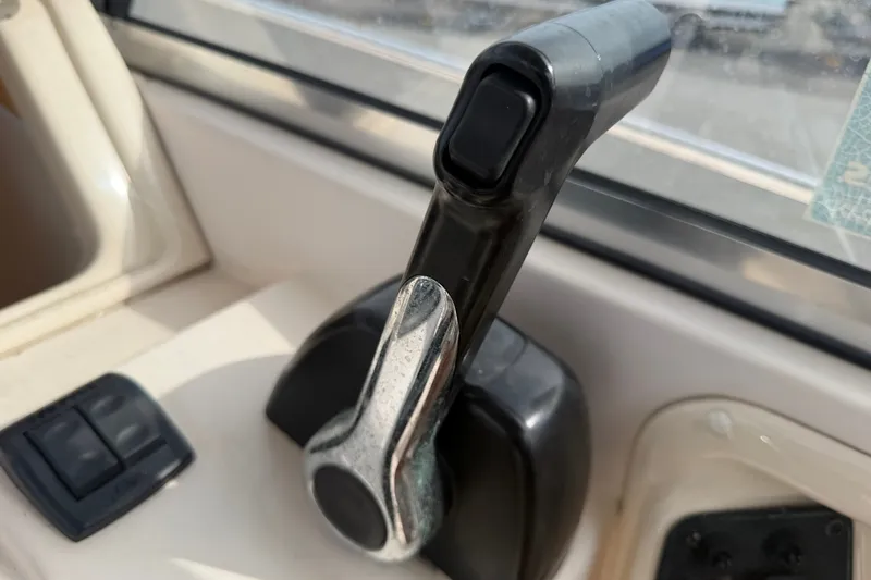 Slide: The Image of Throttle control lever on a 2008 Grady-White Seafarer 228 boat cockpit. - 43