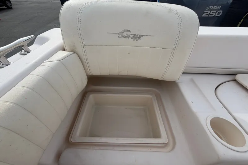 Slide: The Image of 2008 Grady-White Seafarer 228 boat interior with cushioned seating and storage compartment. - 74