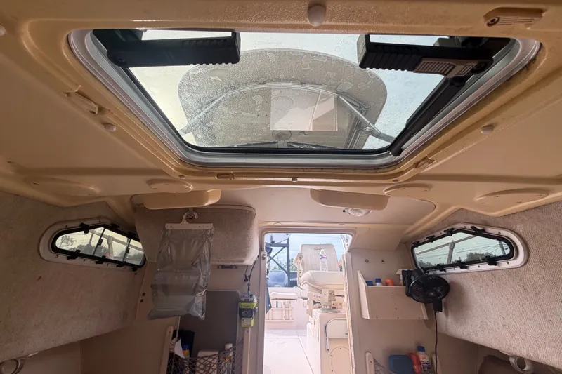 Slide: The Image of Interior view of 2008 Grady-White Seafarer 228 cabin with skylight and storage compartments. - 53