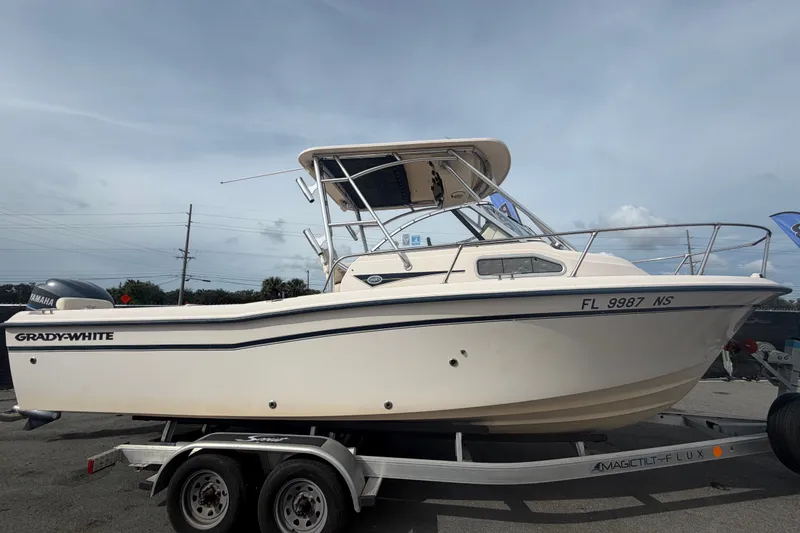 Slide: The Image of 2008 Grady-White Seafarer 228 boat on trailer, side view, clear sky background. - 1