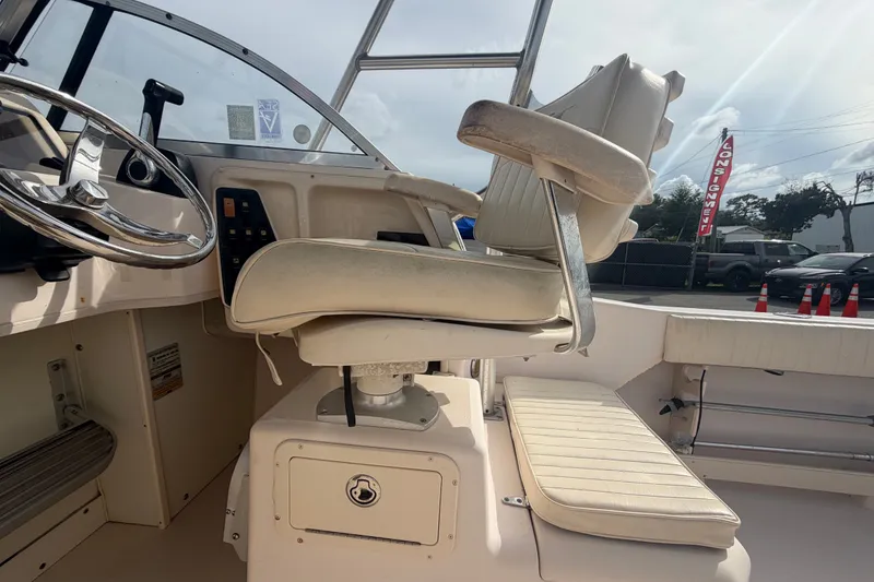 Slide: The Image of 2008 Grady-White Seafarer 228 boat interior with steering wheel and seating. - 25