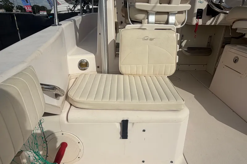 Slide: The Image of 2008 Grady-White Seafarer 228 boat interior with cushioned seating and steering area. - 17