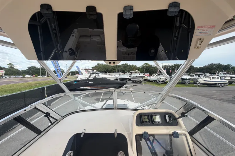 Slide: The Image of 2008 Grady-White Seafarer 228 boat dashboard and controls at a marina. - 31