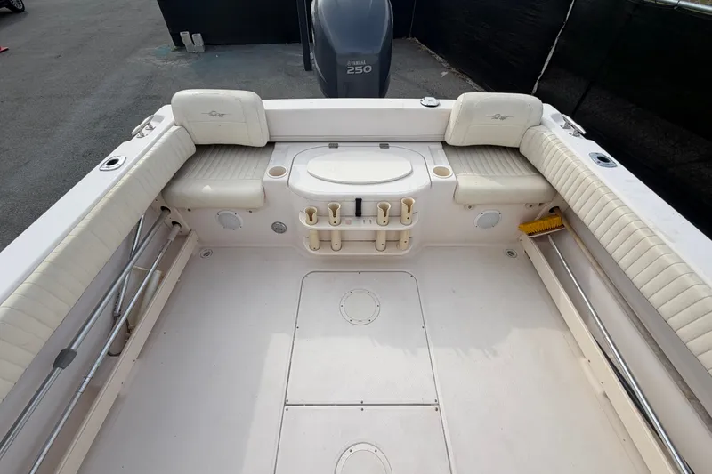 Slide: The Image of 2008 Grady-White Seafarer 228 boat interior with cushioned seating and storage compartments. - 69
