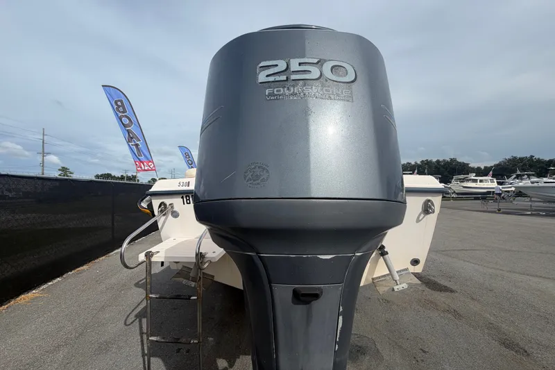Slide: The Image of 2008 Grady-White Seafarer 228 with powerful 250 horsepower outboard engine, displayed at a boat sale. - 3