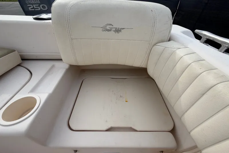 Slide: The Image of 2008 Grady-White Seafarer 228 boat seating area with cup holder and storage compartment. - 80