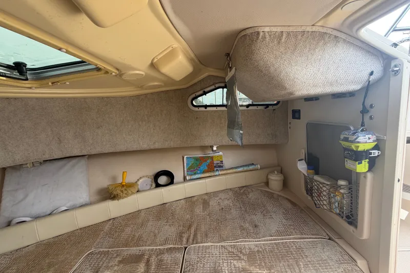 Slide: The Image of Interior cabin of 2008 Grady-White Seafarer 228 boat, featuring cozy sleeping area and storage. - 51