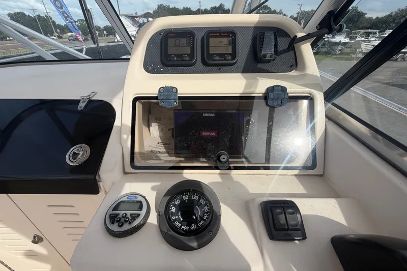 Slide: The Image of Dashboard of a 2008 Grady-White Seafarer 228 boat with navigation instruments. - 37