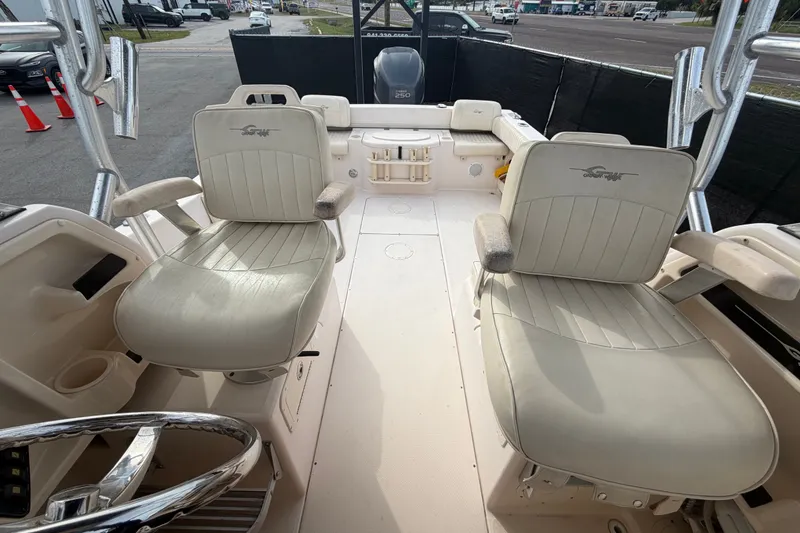 Slide: The Image of 2008 Grady-White Seafarer 228 boat interior with dual captain's chairs and steering wheel. - 63
