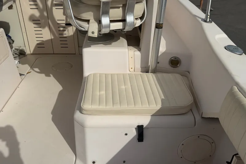 Slide: The Image of 2008 Grady-White Seafarer 228 boat interior with cushioned seating and storage compartments. - 20