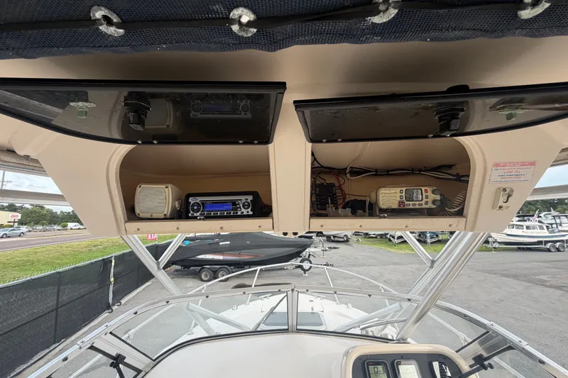 Slide: The Image of 2008 Grady-White Seafarer 228 boat dashboard with radio and navigation equipment. - 32