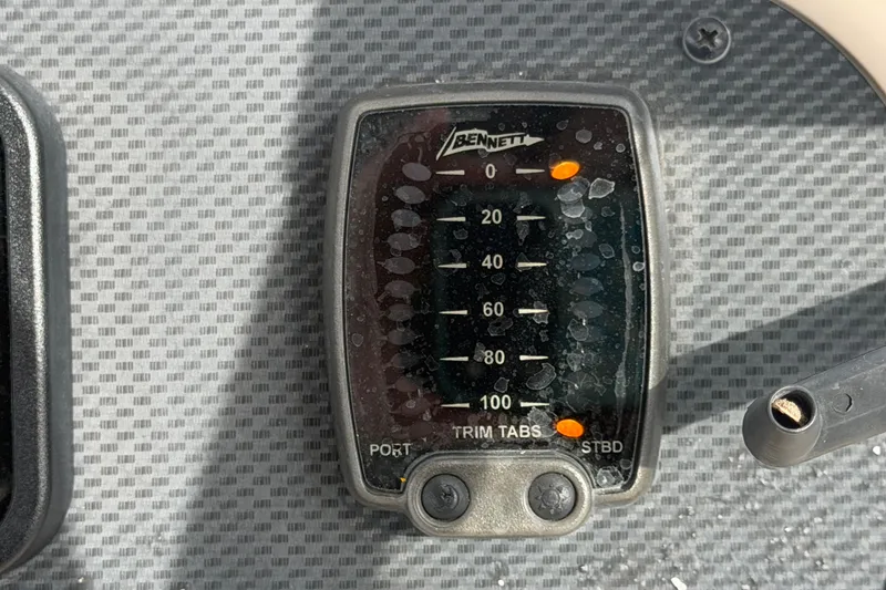 Slide: The Image of Bennett trim tabs control panel on 2008 Grady-White Seafarer 228 boat dashboard. - 41