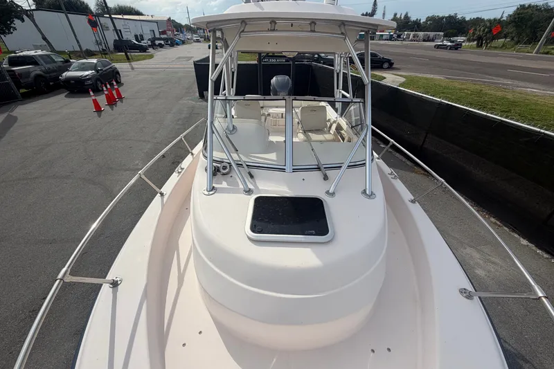 Slide: The Image of 2008 Grady-White Seafarer 228 boat docked, showcasing spacious deck and sturdy railings. - 60
