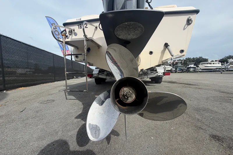Slide: The Image of 2008 Grady-White Seafarer 228 boat propeller and stern view in a marina setting. - 4