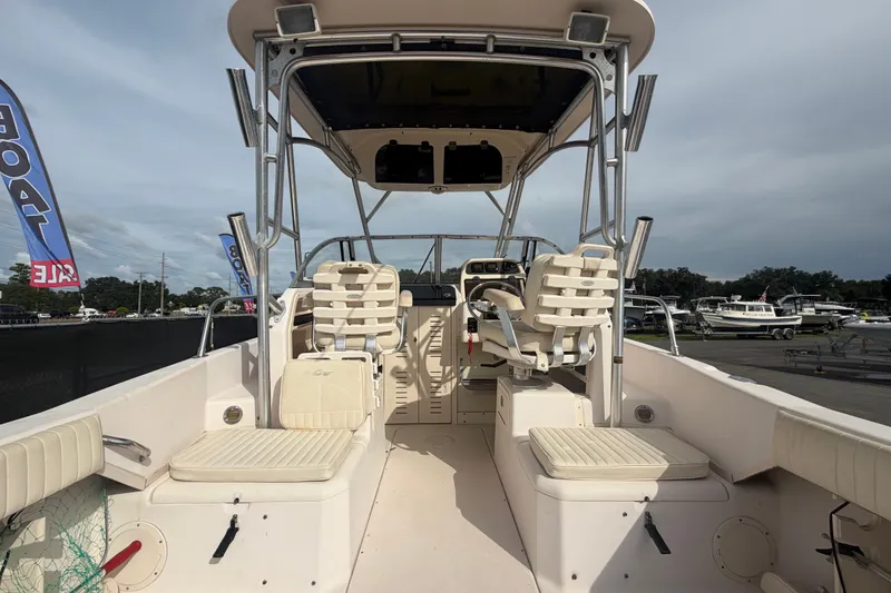 Slide: The Image of 2008 Grady-White Seafarer 228 boat interior with seating and helm, displayed outdoors. - 15