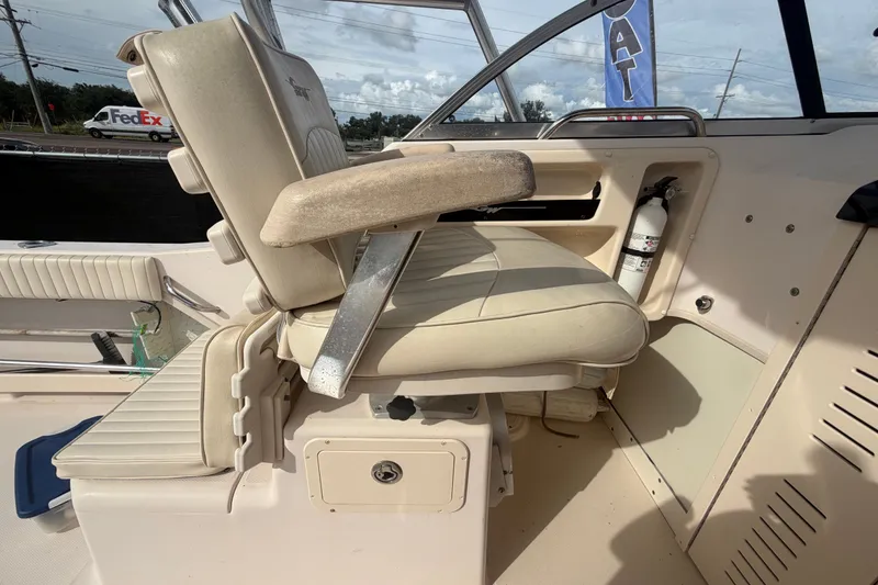 Slide: The Image of 2008 Grady-White Seafarer 228 boat interior with beige seating and fire extinguisher. - 28