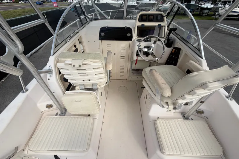 Slide: The Image of 2008 Grady-White Seafarer 228 boat interior with steering wheel and seating. - 22