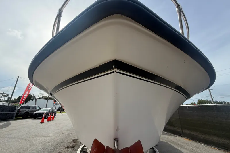 Slide: The Image of 2008 Grady-White Seafarer 228 boat, front view, parked on a street. - 10
