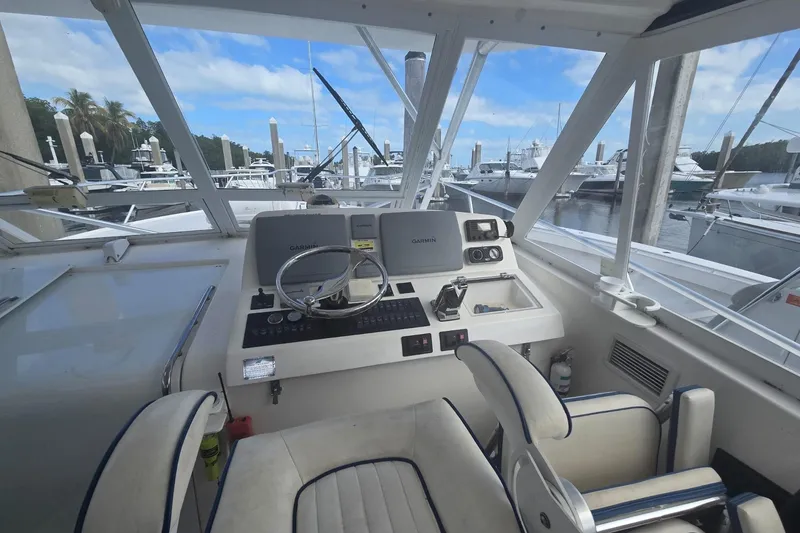 Slide: The Image of 2008 Luhrs 41 Open helm with Garmin navigation, docked at marina under blue sky. - 39