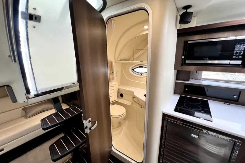 Slide: The Image of Interior of 2018 Monterey 355 Sport Yacht featuring kitchenette and bathroom. - 46