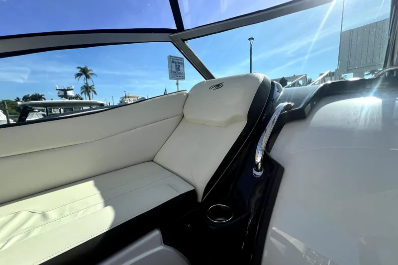 Slide: The Image of Interior of 2018 Monterey 355 Sport Yacht with white seating and sunny marina view. - 104