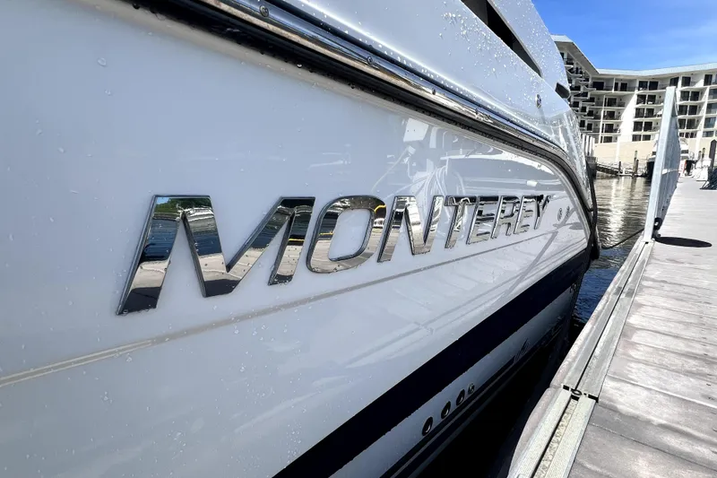 Slide: The Image of 2018 Monterey 355 Sport Yacht docked, showcasing sleek design and chrome logo. - 24