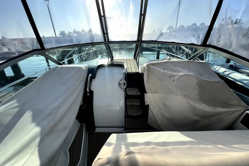 Slide: The Image of 2018 Monterey 355 Sport Yacht interior with covered seating, docked at marina. - 34