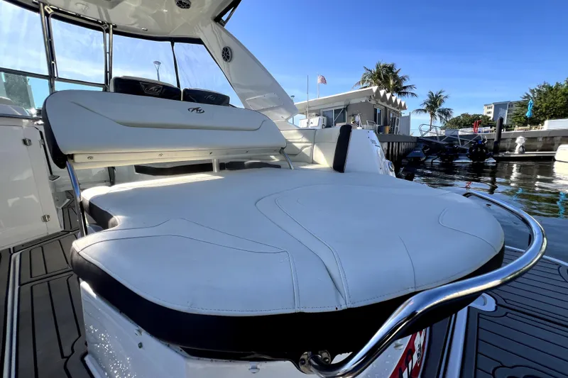 Slide: The Image of 2018 Monterey 355 Sport Yacht interior with luxurious seating and sleek design at a marina. - 28