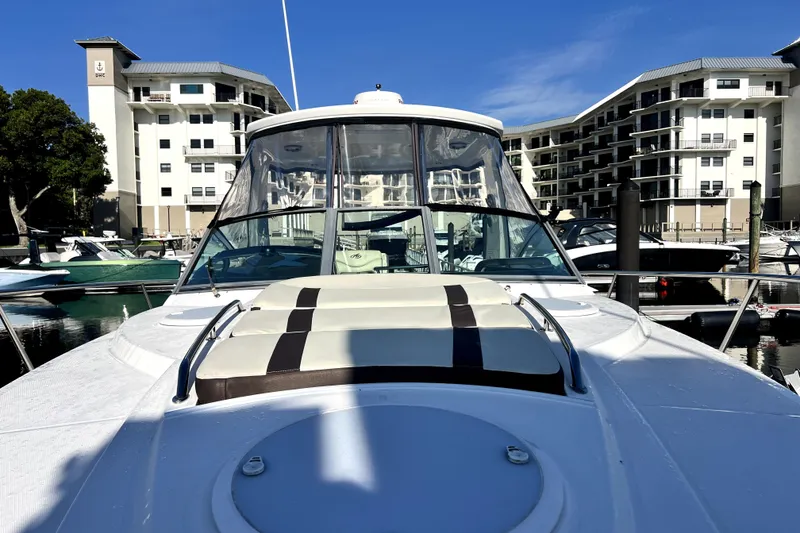 Slide: The Image of 2018 Monterey 355 Sport Yacht docked at marina with modern buildings in background. - 72