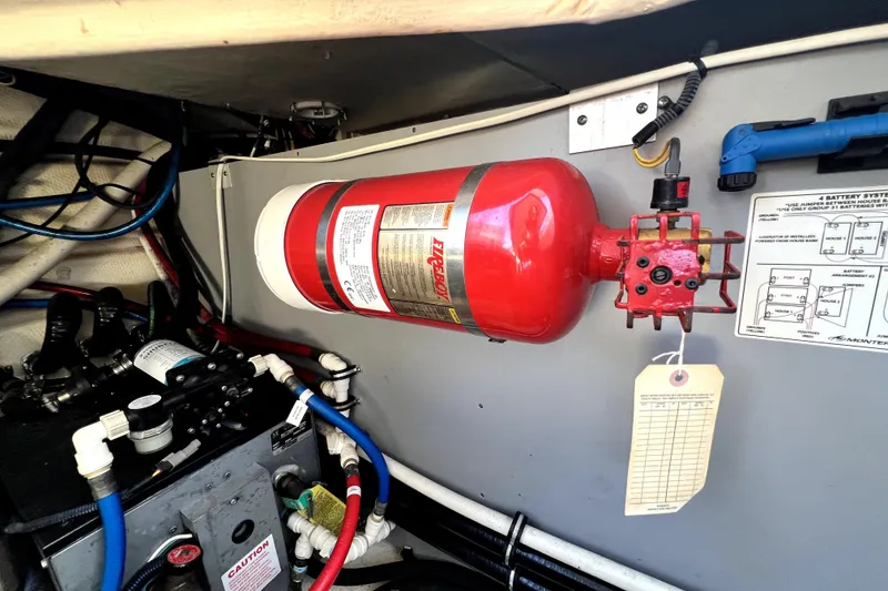 Slide: The Image of Engine compartment of 2018 Monterey 355 Sport Yacht with fire extinguisher and battery system diagram. - 58