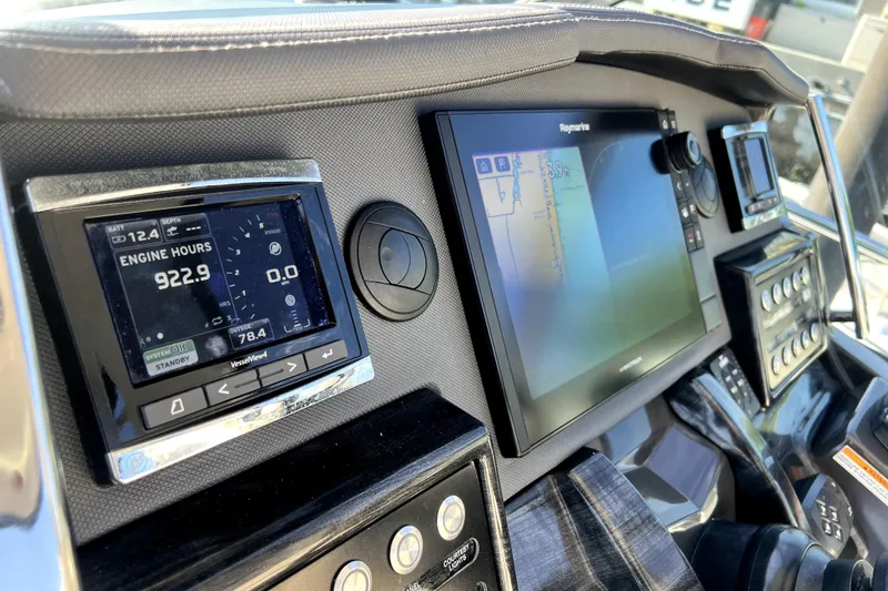 Slide: The Image of Dashboard of a 2018 Monterey 355 Sport Yacht with navigation and engine displays. - 64