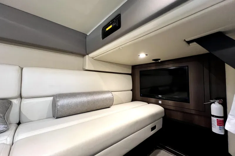 Slide: The Image of Interior of 2018 Monterey 355 Sport Yacht with plush seating and mounted TV. - 83