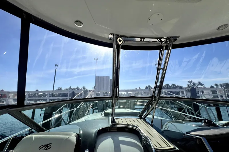 Slide: The Image of 2018 Monterey 355 Sport Yacht interior view with clear skies and marina backdrop. - 56